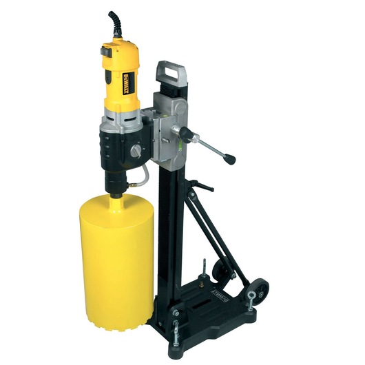 A DEWALT core drilling machine mounted on a black stand with wheels, featuring a yellow motor unit and a large yellow cylinder drill bit. The machine has a side handle for operation, and it is designed for drilling concrete or masonry surfaces.