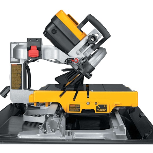 Side view of a DEWALT D24000 tile saw featuring a yellow and black motor assembly, adjustable cutting arm, and sturdy metal base.