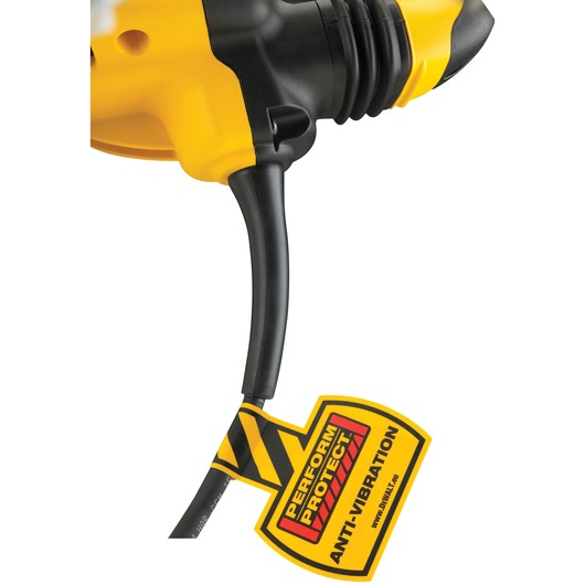 Close-up of a yellow and black DEWALT power tool with a cord attached. There is a yellow tag on the cord that reads 'PERFORM & PROTECT ANTI-VIBRATION'.