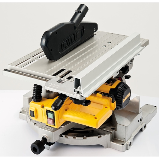 A DEWALT power saw with a yellow base, aluminum table, and black dust extraction attachment, designed for precision cutting tasks.