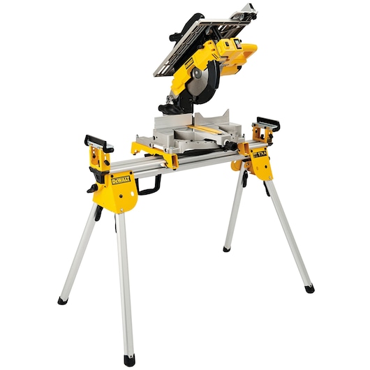A DEWALT D27113 multifunction saw, featuring a yellow and black design. The tool is mounted on a sturdy metal stand with four legs, suitable for woodworking and construction tasks.