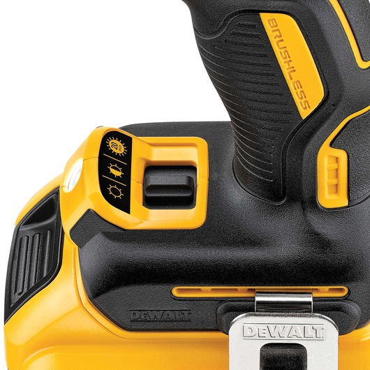 Close-up of a DEWALT cordless drill handle with brushless motor and a three-setting light control switch.