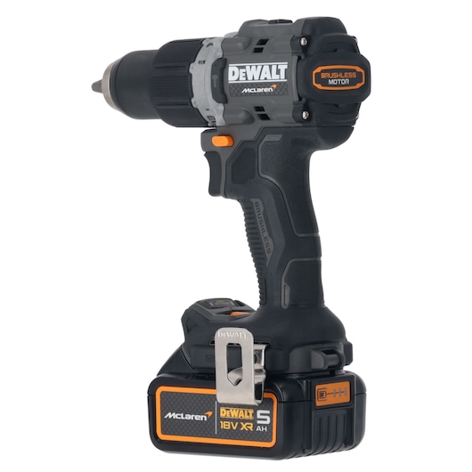 A DEWALT cordless drill with brushless motor, featuring McLaren branding and an 18V XR 5AH battery. The tool is black with orange accents and includes a metal belt clip.