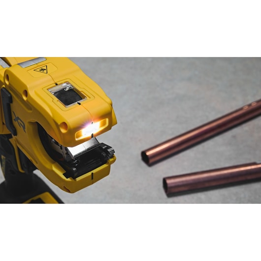 DEWALT DCE154N, DCE154N-XJ pipe tool in use near copper pipes. Photography product.
