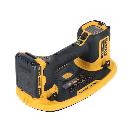 DEWALT cordless electric grabo lifter, shown at an angle. The device features a yellow and black handle, an 18V battery, a digital display on top, and a large suction pad base for lifting heavy materials.