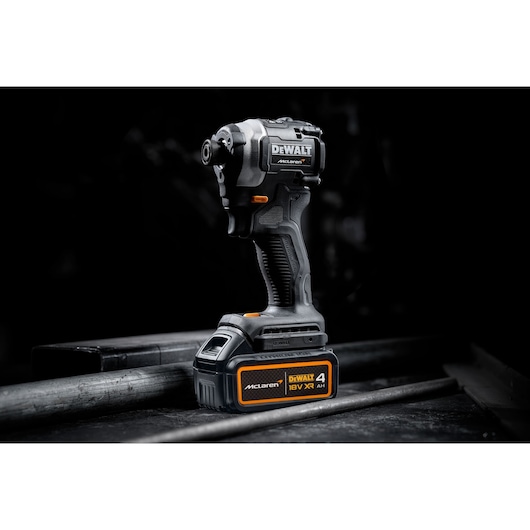 DEWALT 18V XR McLaren cordless impact driver with 4Ah battery, shown upright against a dark background.