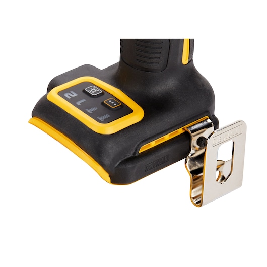 Close-up of the base of a DEWALT cordless power tool, showing the control buttons and a metal belt clip attached to the side.
