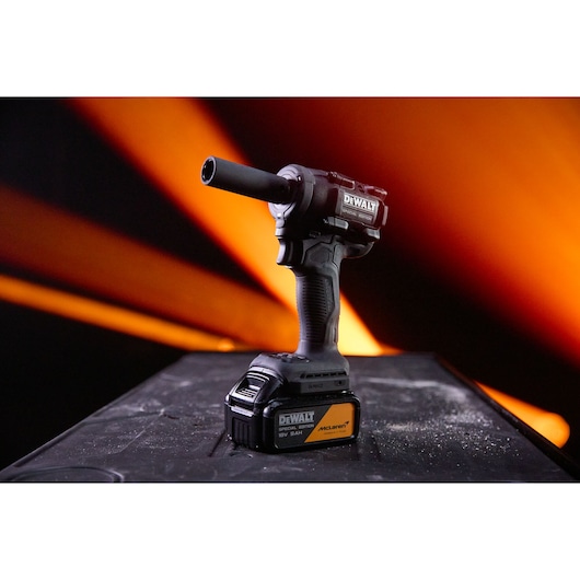 DEWALT photography tool with SKUs DCF92MP2T-QW, DCF92MP2T on a table, orange lights in background.