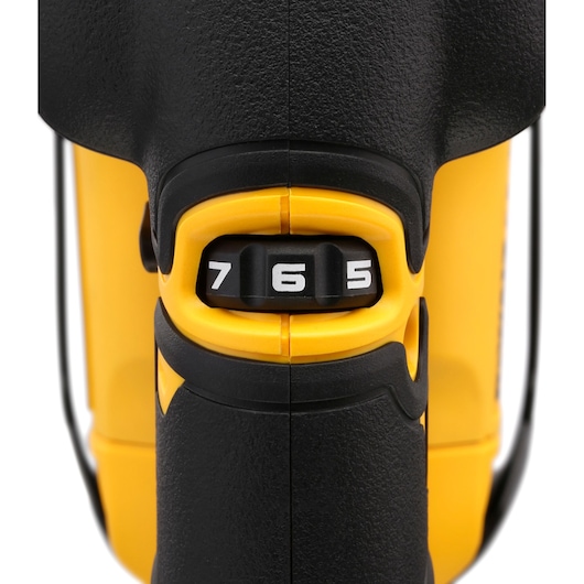Close-up of the DEWALT DCS334NT tool speed dial with numbers 5, 6, and 7 on a black and yellow body.