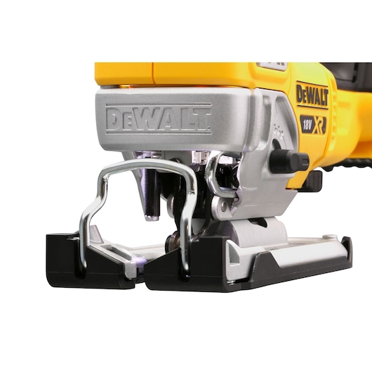 Close-up of a DEWALT 18V XR jigsaw with metal blade guard, yellow and silver construction.