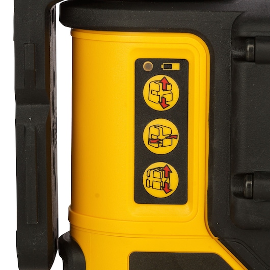Close-up of the side of a yellow DEWALT laser level (SKU DW089K) showing three instructional icons for device adjustment and operation, plus a battery indicator, on a black and yellow background.