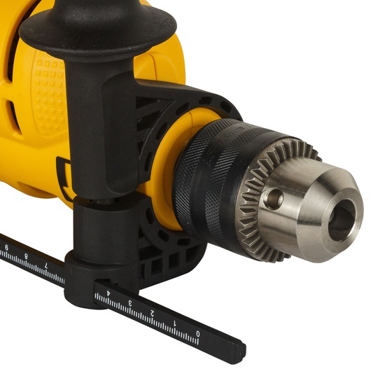 Close-up view of the chuck and depth gauge on a yellow DEWALT electric drill.