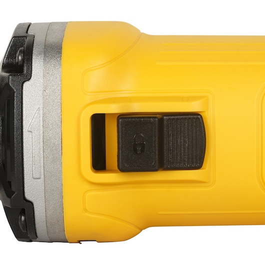 Close-up view of the yellow body of a DEWALT DWE4884 power tool, showing its black switch with a lock symbol.