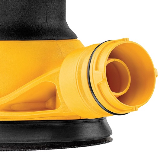 Close-up view of a yellow and black DEWALT power tool showing the dust port and part of the sanding disc.