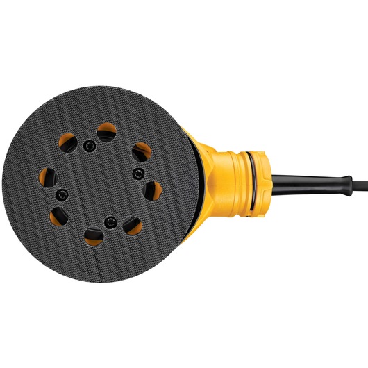 Close-up view of a DEWALT DWE6423 yellow and black electric orbital sander, showing the round sanding pad with ventilation holes and attached power cord.