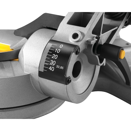 Close-up of a DEWALT mitre saw adjustment dial with angle scale and locking handle.