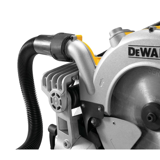 Close-up of a DEWALT mitre saw blade with attached dust extraction hose.